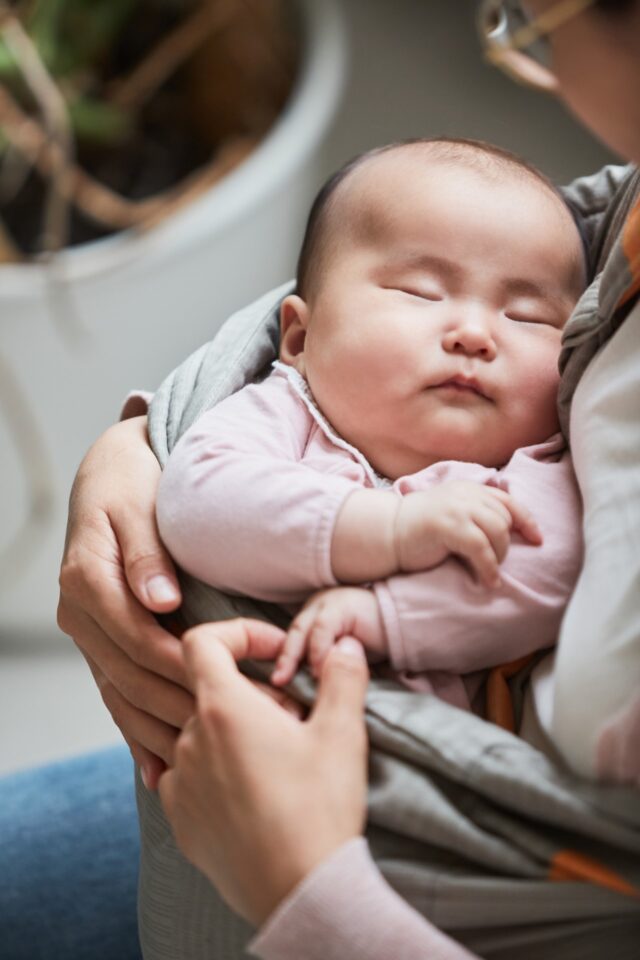 Baby Sleeping on Mother's Hands